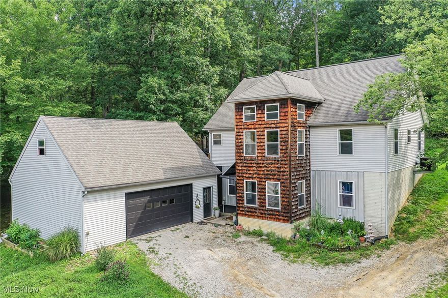 Industrial meets rustic in this unique and captivating home just outside of town! Floating stairs and a towering wall of windows are just a few of the wow design features. Enter into the walk-out basement that features huge recreation/gym space, office, 1st floor laundry and full bath. 2nd main level has open kitchen with bar seating and stainless steel appliances, 2 beds and bath. The 3rd level has a giant primary suite that spans the footprint of the house with jetted tub and balcony. Immerse yourself in nature and the Hocking Hills and enjoy views of greenery, rock formations and wildlife from the large deck and outdoor brick patio. From the deck you enter into a loft above the 2 car garage that could be converted into extra living space! Could be up to 5 beds! So much potential! May qualify for 100% financing!