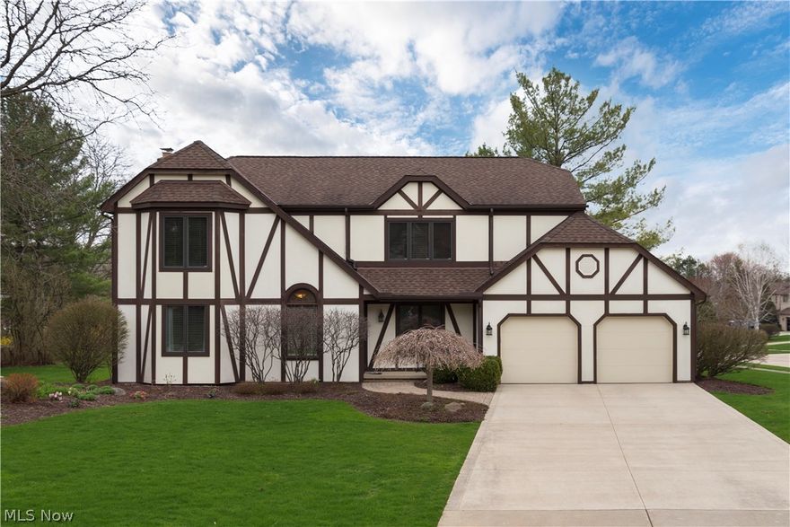 Welcome to 5025 Boulder Creek Drive! This turn-key, storybook Tudor in Solon is completely updated and meticulously maintained, just waiting for you. As you enter, the light two story foyer gives way to a formal dining room on your left, with gleaming hardwood floors. To your right, an office with tray ceiling and lots of natural light. Make your way into the eat-in kitchen, with tile floors, stainless steel appliances including a double oven, trash compactor, custom cabinetry, and gorgeous countertops. Take a seat at the bar or table, and enjoy quick access to the deck overlooking the large backyard. A cozy family room offers a beautiful gas fireplace with stone surround, and built-in shelving and window seat. A laundry room with lots of storage and a half bathroom complete the first floor. Upstairs, the master suite features vaulted ceilings and two walk-in closets. Step into the ensuite, noticing the oversized tile shower with glass surround, and wide vanity with custom cabinetry fo