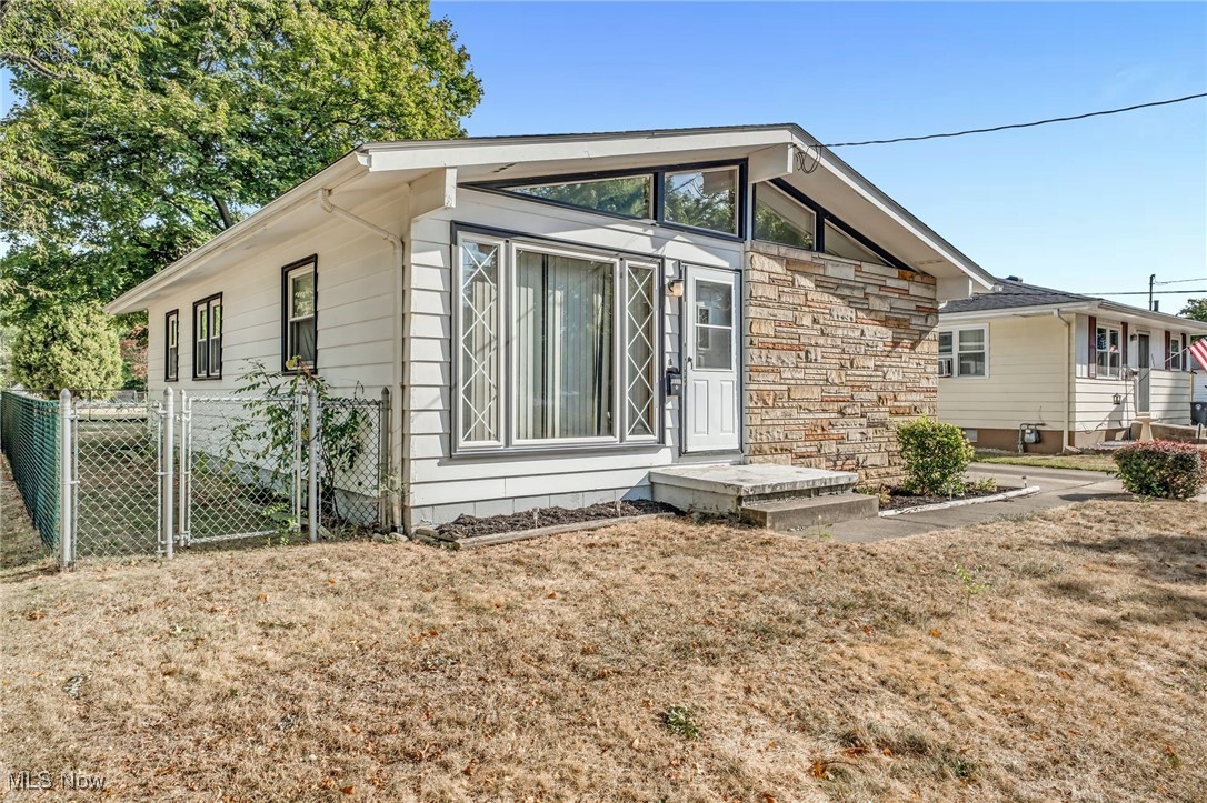 Welcome to this beautifully maintained, move in ready home tucked away in the highly sought after Ellet neighborhood. Perfectly positioned just minutes from the expressway, schools, parks, and conveniences, this property blends comfort, character, and practicality in a way that truly sets it apart. From the moment you arrive, pride of ownership is unmistakable as the home has been lovingly cared for and it shows in every detail. Inside you’ll find the charm of original hardwood floors paired with soaring cathedral ceilings that make the living room feel both open and inviting. Sunlight pours through large windows, highlighting the spacious design and creating a bright, welcoming atmosphere that flows into the open concept eat in kitchen, the true heart of the home where there’s plenty of space for everyday meals, entertaining, or gathering with family. With three bedrooms, two full baths, and a flexible office space, the layout works beautifully for a variety of lifestyles whether you need a home office, guest room, or playroom. A recently added sunroom expands the living space even further and enjoy views of the backyard year round. Step out onto the newer deck that overlooks a fully fenced backyard with a gated driveway, providing both privacy and peace of mind while also offering the perfect setting for outdoor entertaining. The lower level includes a partially finished basement with a versatile rec room complete with built ins that can be used as a media room, game room, or home gym, while storage and parking are never an issue thanks to an oversized detached garage and a wide concrete driveway. This home strikes the perfect balance between timeless charm. Don't miss this amazing opportunity and schedule your private showing today!