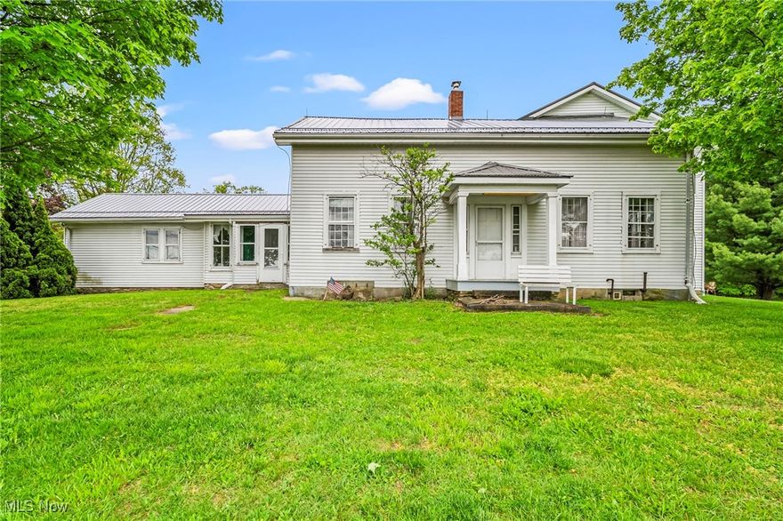 Full of rustic charm and untapped potential, this historic farmhouse sits on 5.85 picturesque acres, offering a rare chance to restore a piece of the past. It is in a great commute location in Parkman Township, Geauga County & Cardinal Schools. The original part of the home has a layout that invites creativity and vision.  According to the seller, in 2006 a 28x26 pole barn was built & the wood shed attached to the farm home was removed & a 2.5-car attached garage constructed. They added a laundry room, dining room and full bath above the garage for an in-law suite.  Within a year, the larger bedroom in the original home was remodeled adding 2 walk-in closets, a storage closet  & 1/2 bath. 5 years later 2 smaller rooms were remodeled into another bedroom w/walk-in closet.  A large deck was attached to the back of the home. An extra wide stairway leads from the garage to the 2nd floor suite and there are also exterior stairs to the unit above.  When the highway was widened, the state erected an impressive retaining wall with wrought iron fencing leading up the drive from the road.  What makes this home unique is that you have 2 separate living spaces, where you could make it a multi-generational home, remodel to make one extremely large home or rent one unit and live in another.  Metal roof 6/24, Furnace serviced 4/24, heat pump & air handler replaced 6/23, both septic tanks pumped 4/24 and installed a new outlet tee on the 2nd tank.  Older outbuildings include a granary and a 3 bay garage/barn--both in need of repairs, or to be torn down to create an outdoor space that works for you. Known as Pennview Farm, come get a magnificent view all the way to PA!