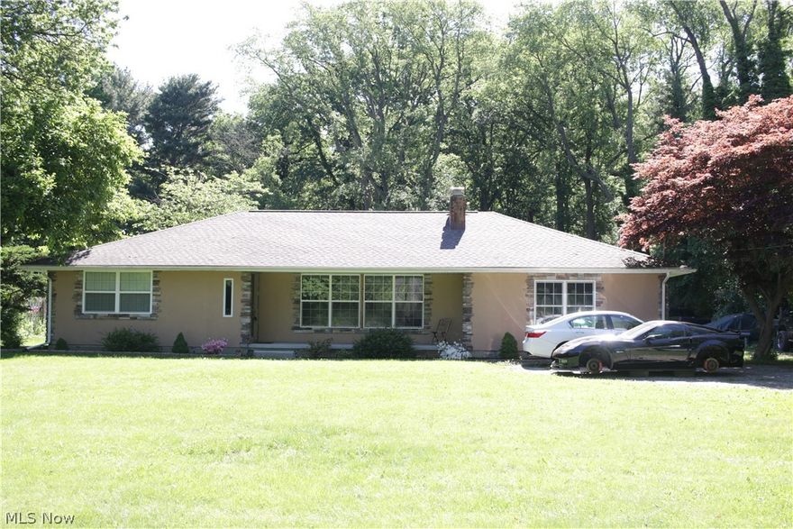 Wow.  What an opportunity.  An acre of land set back from the street with a turn around drive and plenty of room for vehicles including the detached 6+ car garage.  Enter the foyer and be amazed by the living room with cathedral ceiling and upgraded finishes complementing the wood burning fireplace.  
Huge living space.  Full Bathroom off of the kitchen and a full bath adjoining the bedrooms.  The covered deck off of the kitchen, and the 18x36 saltwater pool will bring the family together.  Plenty of finishing potential in the basement with a second fireplace.