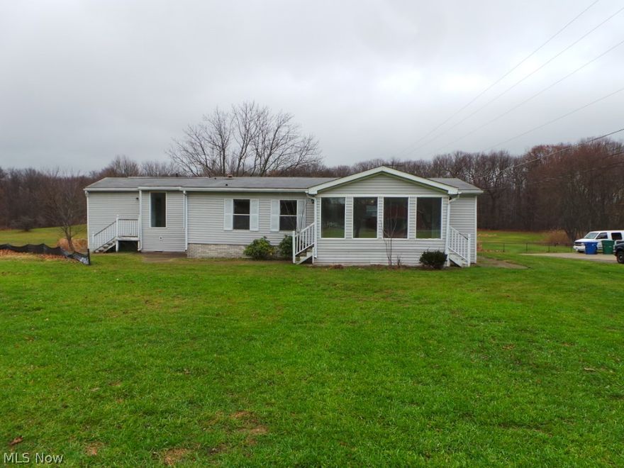 Country setting, home includes two parcels for approx 3/4 acre. Large front porch , three bedrooms and three full baths. Home has been determined to be a mobile home.  Property sold AS IS.