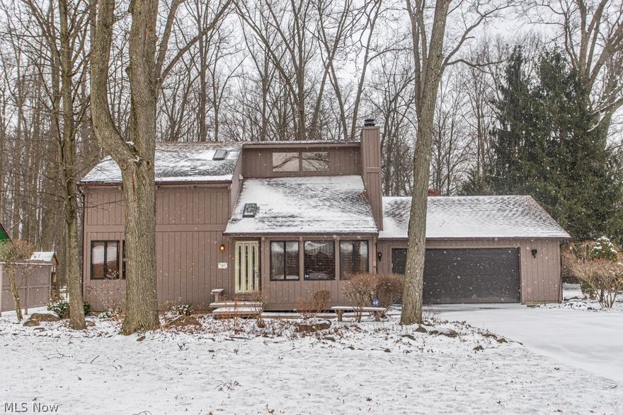 This beautifully designed 3-bedroom, 2-full-bath home features an open, inviting layout and a dramatic two-story living room anchored by a floor-to-ceiling custom stone fireplace. The fireplace creates a warm, welcoming focal point while adding charm, ambiance, and cozy comfort during Ohio’s colder months.

The open floor plan enhances everyday living and entertaining, allowing natural light to flow throughout the main living areas and creating a spacious feel ideal for gatherings, holiday hosting, and staying connected with family and guests.

A first-floor bedroom and full bath provide flexibility and convenience, while the first-floor sunroom offers valuable additional living space. This bright, versatile room is perfect for morning coffee, reading, plant sanctuary, or relaxing while enjoying peaceful views of the wooded surroundings.

Upstairs, two additional bedrooms provide comfort and privacy. The home also includes a full basement for storage or future finishing, a two-car garage, and a private wooded lot that adds natural beauty and tranquility. All appliances stay.