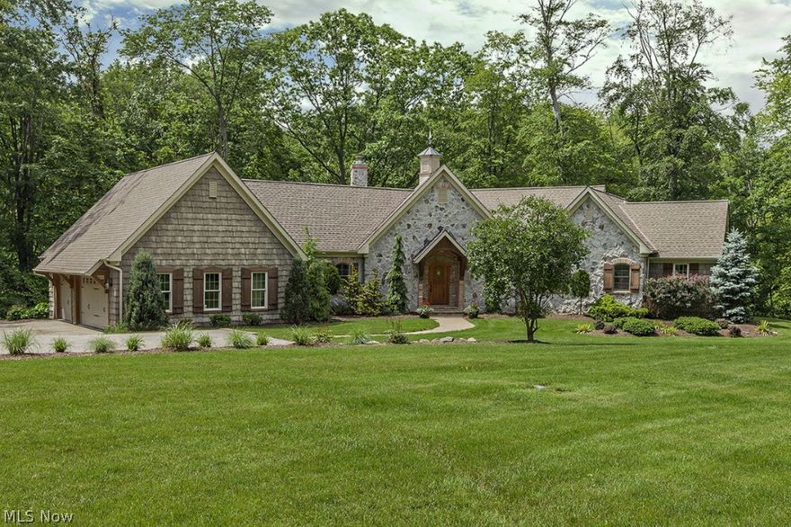 Set back from the street sits this beautiful, pristine stone & cedar ranch on 16 wooded acres. Built in 2005, it is ideal for those who want quality, privacy, 1st floor living, high ceilings, a large  owners suite with a fabulous spa-like modern Travertine Bath that’s removed from the other bedrooms, an in-ground pool for fun & relaxation, & no HOA or HOA fees. The main level is all about the owners while the lower level is for the children, overnight guests, & casual entertaining. Gorgeous Patagonian Rosewood floors grace the gourmet knotty alder & granite center island Kitchen, the adjoining Hearth Room & Dinette, secret walk-in Pantry, vaulted beam ceiling Great Room with 2-sided Fireplace, Hallway & Library. The home also has a warm neutral color palette, huge vaulted knotty pine 3-Season Porch, Family Room with floor-to-ceiling stacked stone fireplace, custom cabinetry, solid wood trim, a Geothermal heating system (means low heating costs), patio, & 2 additional build-able lots.