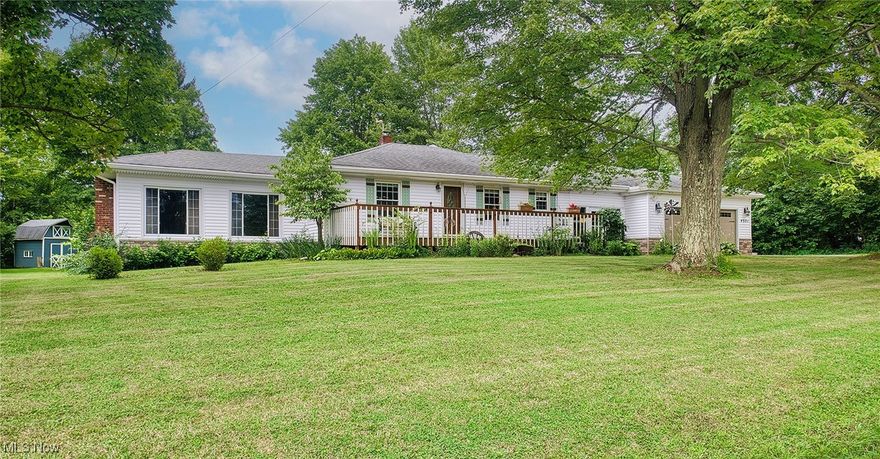 Come and see this rare find in the Cuyahoga Valley National Park!  You maintain an acre of park-like living and enjoy being surrounded by 30,000 acres of National Park.  This home features two distinct living areas.  One side of the home provides an eat-in kitchen/dining room combination with solid wood cabinets and solid surface counters. On this side one bedroom has been set up as a fully-functioning home office but could easily be converted back to a bedroom.  Then, there is the family room with vaulted ceiling and fireplace - plus - a primary suite with its own private bathroom and laundry. The other side of the home has been designed with a second bedroom suite area - perfect for guests or for house-sharing.  It has a full bath and living room area of its own.  But - there is so much more than the house to enjoy here!  A breezeway connects the home and garage. Anyone who likes working on cars (or wants to store one for the winter) will enjoy the built-in Max Jax and workbenches in the mechanic-friendly garage.  Then, there are two barns out back.  One has been used as a shop; it is insulated, has electric and has a wood burning stove for heat. The other has the potential for an animal or chicken coop.  Lovely raised beds and a wide front porch help to complete the country feel and each spring you will have perennials pop up to surprise you!  The home has Cuyahoga Falls electric, water and trash and there is a newer Generac Generator for peace of mind.  Woodridge Schools, too!