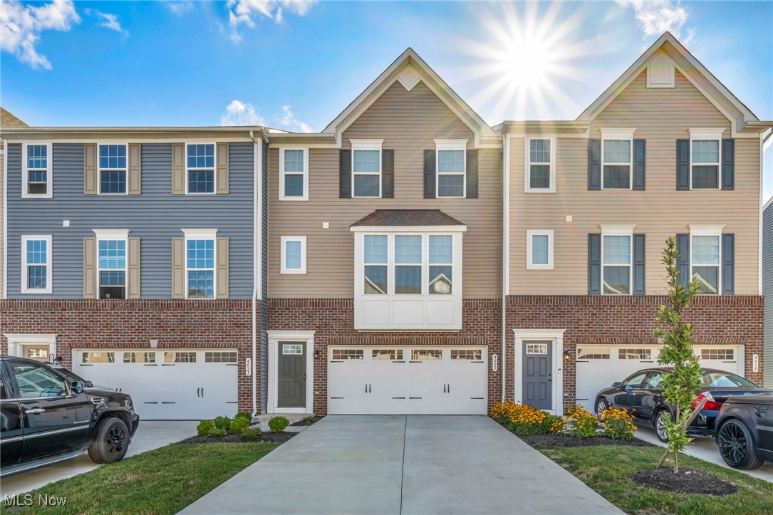 Welcome Home! A beautifully crafted townhome located in one of the most desirable areas of Cuyahoga Falls—the sought-after Towns at Steels Corners community. Built in 2022, this modern three-level residence offers nearly 1,900 square feet of thoughtfully designed living space, with 3 spacious bedrooms and 4 bathrooms—including 2 full baths and 2 half baths—providing a perfect balance of comfort, function, and style. The open-concept main floor showcases luxury vinyl plank flooring, granite countertops, a sleek tile backsplash, and a large kitchen island that anchors the living space—ideal for entertaining, meal prep, or casual dining. Upstairs, the spacious primary suite features a large walk-in closet, dual vanities, and a Roman-style ceramic shower. Two additional bedrooms and a full bath complete the upper level. The finished lower level includes a versatile bonus room with its own half bath—great for a home office, media room, or gym. Step outside and enjoy your newly poured concrete patio, perfect for relaxing or hosting friends and family, along with a raised garden bed in the backyard—ideal for growing fresh herbs, vegetables, or flowers. The attached two-car garage and ample storage throughout the home ensure day-to-day convenience. Located just minutes from major local attractions such as Blossom Music Center, Cuyahoga Valley National Park, Brandywine Falls, and Sarah’s Vineyard, this home is also a short drive from the shops, restaurants, and trails of Downtown Cuyahoga Falls. With quick access to Route 8, commuting to Akron, Hudson, or Cleveland is seamless. As part of a professionally managed HOA community, you’ll enjoy an unbeatable location—making it a true gem in Cuyahoga Falls.