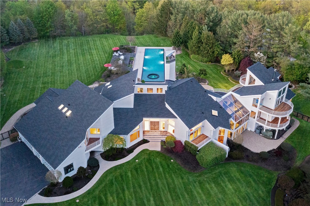 A Once-in-a-Lifetime Contemporary Masterpiece in Moreland Hills. Discover one of the most iconic and architecturally significant contemporary residences in Moreland Hills. Tucked away in a private, natural sanctuary, this one-of-a-kind estate offers a rare fusion of cutting-edge design, serene surroundings, and effortless elegance. The stunning backyard retreat is a work of art in itself—lushly landscaped and thoughtfully curated to provide the ultimate outdoor experience. From tranquil mornings surrounded by nature to vibrant evenings by the expansive pool under the stars, the setting is equally suited for intimate relaxation or unforgettable entertaining. Inside, expansive Richard Meier inspired open-concept living spaces are framed by soaring ceilings, clean architectural lines, and dramatic floor-to-ceiling windows that flood the interiors with natural light. Custom finishes, exceptional craftsmanship, and seamless indoor-outdoor flow define every detail. The dedicated entertainment wing is beyond compare—designed to host and impress at the highest level. Opportunities to own a residence of this caliber in Moreland Hills are exceedingly rare. This is more than just a home—it’s a bold statement, a lifestyle of distinction, and a singular opportunity to own a contemporary showpiece in one of Northeast Ohio’s most coveted enclaves.