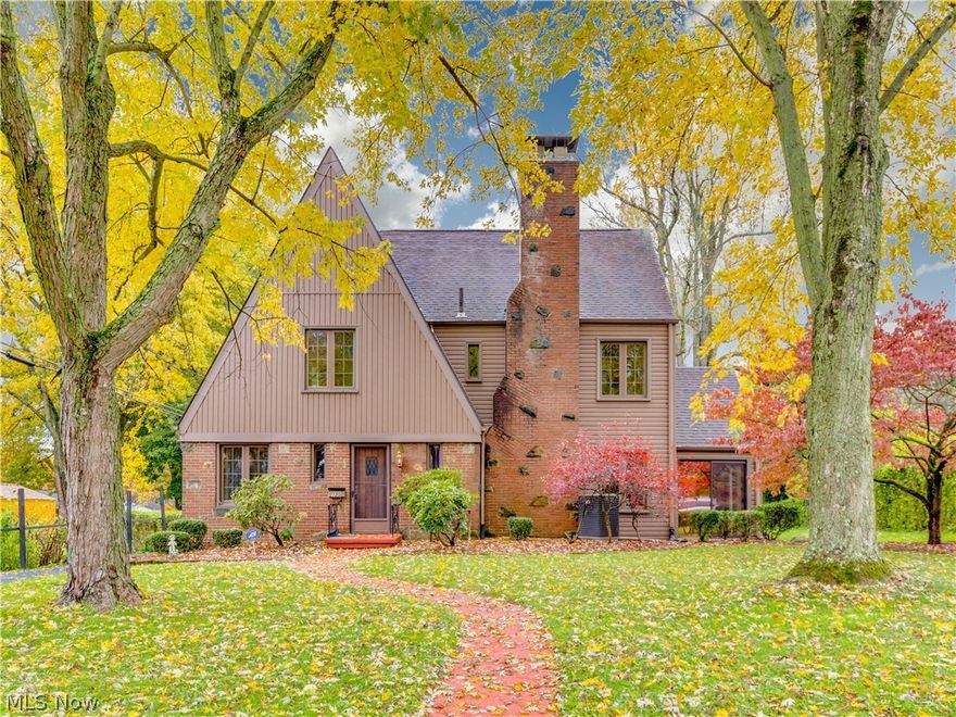 Adorable Tudor home in Canton is one of a kind. Great curb appeal and stylish front. Beautiful mature manicured trees in the large front yard. Oversized two car garage has an area for storage or work shop area. There is an extra parking space beside the garage. This home has beautiful curved archways and beautiful doors. Gorgeous stairway in the foyer with beautiful dark wood. The front living room has a pretty wood burning fireplace and French doors that open up into a 3 season room. The kitchen has pretty grey cabinets, tile, and counter seating. Large dining room with wall of windows looking out of the backyard. A really fun space, is the family room. Huge rock gas fireplace, cathedral ceiling with wooden beams and a sunken entertaining area. The three large spacious bedrooms upstairs have beautiful hard wood floors. The hallway has lovely built-ins. The full bath has shower/tub insert and pretty vanity. The third floor has a walk in closet, another full bath with claw foot tub, and