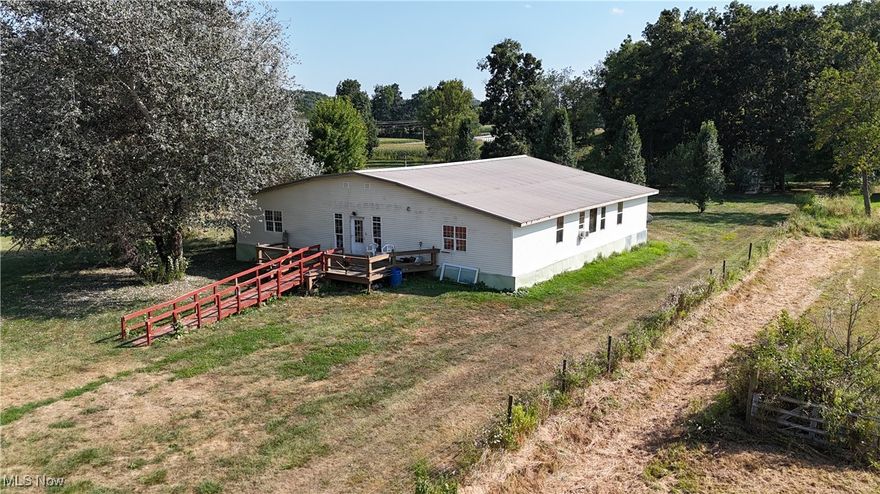 This is a large family home situated on 12.48 acres on a corner lot facing a County Road and a State Highway. The acreage is level with fenced pasture. There is a creek on the property plus a 30 foot and a 25 foot deep pond. There are 3 additional buildings included: a 46'x30' pole building, a 24'x30' building and a 12'x24' building. The home is 4,096 Sq. Ft. with 4 bedrooms, 2 full baths, large eat-in kitchen, plus dining room. There is a recent metal roof plus large handicap ramp.