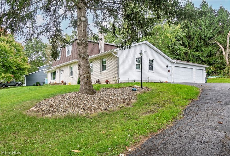 Welcome home to 8615 Hickerylane Avenue in Jackson LSD! A stunning four bedroom, three bathroom colonial located in the desirable Scenic Wonderland Hills development. Sitting on 1.27 acres, this modern home is nestled back 170 ft from the road and features beautiful new landscaping, 3 car garage, and over 2,200 sq ft. The main level owner's suite offers a 2 sided fireplace, two oversized closets, and a beautiful full bathroom. The eat-in kitchen opens to the family room with a floor to ceiling brick, gas fireplace w/firewood storage, newer vinyl flooring, wonderful wall to wall built-ins with buffet and lower cabinetry. Boasting a 4 seasons room w/ remote control heater and beautiful back patio in a private back yard, this home is perfect for entertaining. 3 car garage walks into your rear foyer. Plenty of updates throughout including; a new AC/roof/furnace 2019, carpet 2020, interior doors/siding/high gloss gutters/garage doors/exterior lighting 2021, all new plumbing 2022. Don't miss