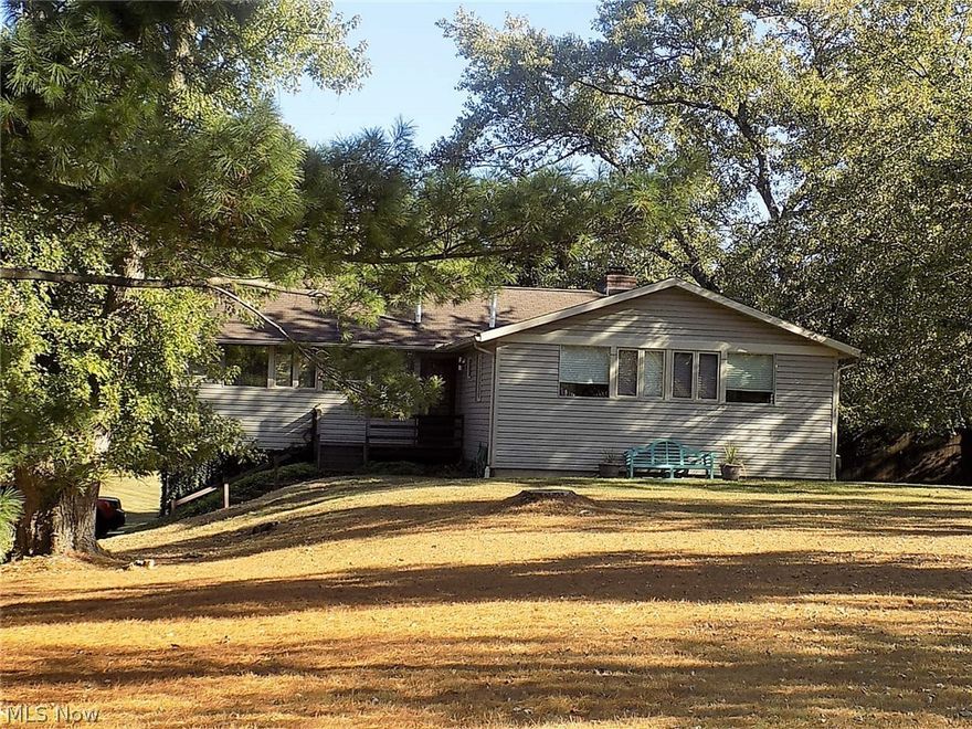 Awesome updated midcentury modern ranch perched on over a 2 acre lot in Bath*From the moment you step into this charming home you will enjoy the engineered wood and hardwood floors, painted wood plank ceiling with beams*The living room has a rustic gas log fireplace, there is an office area behind, dining room, and a screened in porch with tile floor and door to steps going down to a fenced in area*Gourmet cook’s kitchen*Plenty of dark cherry stained shaker style cabinets, granite counters, center island for bar stools, Bosch dishwasher, Sub-Zero refrigerator, Bertazzoni 6 burner commercial grade gas range, SS under mount sink and a walk-in pantry*3 bedrooms with hardwood floors*1 bedroom was converted to a huge walk in closet but can be changed back (closet doors downstairs)*Stunning remodeled bathroom*There is a rec room, storage room, laundry area, another full bath, and a door from garage to a patio that overlooks the rolling backyard*Priced to sell!*Move in condition! Award winnin