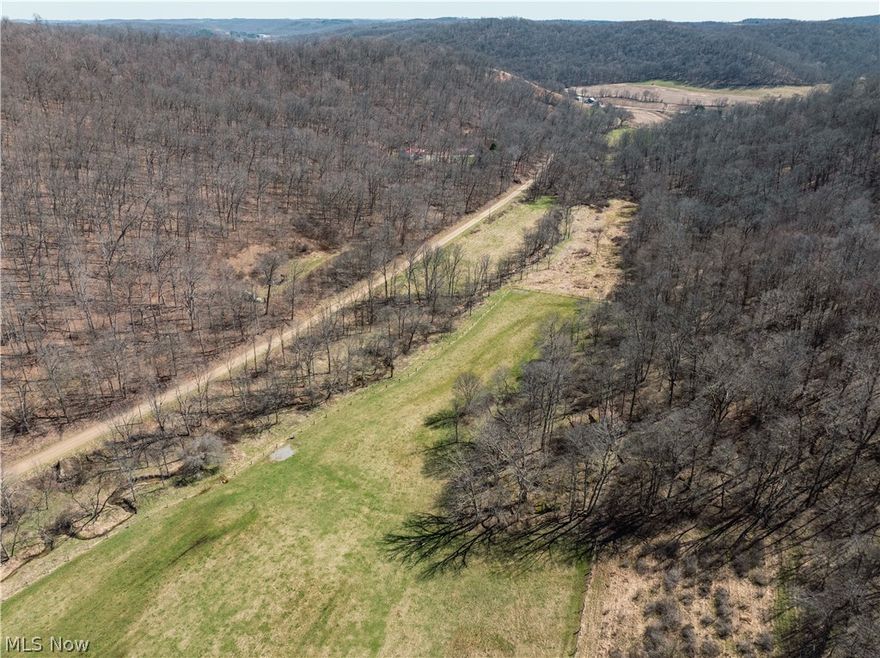Live Auction 5/02/2026 10:00 AM - Parcel 7: 22.6 acres w/ 716’ frontage -This exceptional 188-acre offering of Holmes County land presents a rare to the market opportunity to own real estate in the well-known Stillwell area. Located just seconds from a paved road, the land features an older 3BR 2BA home, a 35' x 56' pole building, private septic, and a spring-fed water supply. The setting of the home offers peace and quiet, privacy, and ample land for gardening or animals. For the hunters, this property is situated in one of the county’s most sought-after hunting areas. Stillwell is well known for its hunting, and this property is no exception. Lots of deer trails, rubs, and scrapes, and each parcel is accessed from the east, providing favorable prevailing wind access and multiple ideal locations for food plots. A well-established trail system runs throughout the property, providing easy access. There is a nice ridgetop that spans most of the property, while the remainder of the land has a nice roll to it with a strong running creek, tons of road frontage, fenced pasture areas and ample building sites throughout. Most of the harvestable timber has already been marked and sold; these trees will be removed following the sale and are not included in the transfer. This selective harvest is expected to enhance the wildlife habitat and improve access with additional trails, bedding/cover, and browse. Whether you’re searching for a peaceful building site, prime hunting land, pasture ground, or just an investment, this property offers endless potential.