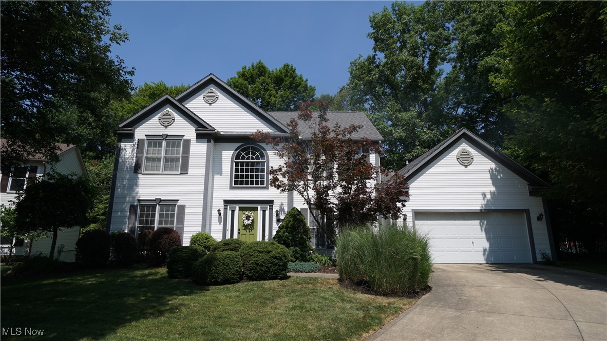 Don’t miss out on this 4-bedroom Tallmadge Hills colonial set on a wooded cul-de-sac lot with secluded backyard. This beautifully maintained 2,356 sq. ft. home marries open spaces for entertaining with isolated rooms like a Home Office or Sitting Room designed for more reserved moments. Striking curb appeal welcomes you across the front porch into the 2-story Entry with hardwood flooring. The voluminous entry is flanked by a substantial Home Office as well as a charming Living Room. Down the hardwood hall, you are met by a stunning wall of windows framing a classic brick fireplace in the massive sunken great room where 9’ ceilings are accented by a cathedral ceiling above the fireplace. A conveniently located Eat-in Kitchen is equipped with stainless steel appliances including range, range hood and dishwasher. Additional amenities include granite countertops with stainless undermount sink, tile backsplash, peninsula with breakfast bar and pantry closet. Sliding glass doors provide access to the newly installed deck from the dining area. 1st floor laundry room with utility sink and a guest bathroom round out the main level. Upstairs, a sizable Owner’s Suite with Cathedral Ceilings anchors the sleeping quarters. A generous Walk-in Closet and Ensuite Bathroom with dual vanities, garden tub, and shower stall provide genuine convenience. 3 additional spacious bedrooms with roomy closets and a nicely appointed full bath with shower/tub combo complete the upper level. An expansive basement has been partially finished with areas separated with drywall walls and glass block windows. There’s plenty of room for storage with built-in wooden storage racks. Outside, a nicely landscaped front path leads to the driveway where an oversized 2-car garage has lofted storage in the rear. The backyard has pristine wooded views onto the neighboring pond. Updates include: Deck ’25, Carpet ‘21, A/C ‘19, Furnace and Hot Water Tank ’18, and Roof ’12.