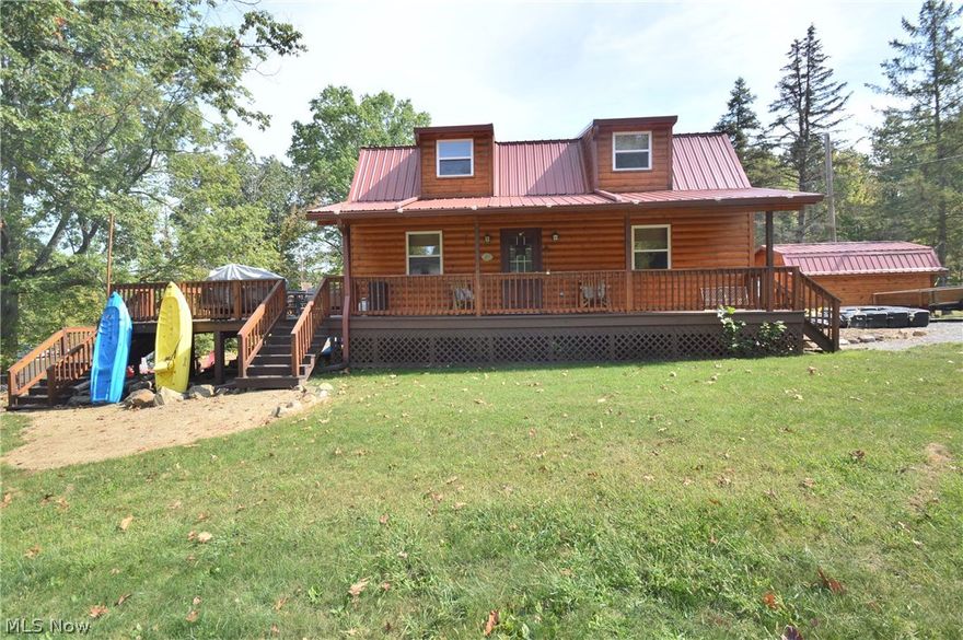 5 year old waterfront Cabin on Lake Milton.  The open main level of this home plays host to great room with 17 foot ceilings; a dining room; a spacious kitchen; a master bedroom; and a full bath.  A spacious bedroom loft comprises the second level.  A finished basement provides a recreation room, full bath, laundry area, and ample storage.  Exterior features include a covered porch, a large deck with hot tub, and a storage shed.  This property is nestled on a dead end street.  Enjoy your dock in the private cove setting with no wake while being just minutes from the wide open water via boat.  This home is like new and move in ready.  Call today!!