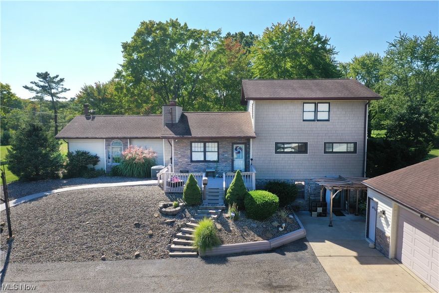 This beautiful custom 5 bedroom 2 bathroom home includes over 12 acres of space to play!  Built in 1955 and transformed throughout the years, it has stunning craftsmanship! Upon entering this home you will be welcomed by the first of three gas/wood fireplaces! Through the large dining room you can step down into the gorgeous great room (added in 2000) which features tons of natural light, cathedral ceilings, wood beams and a hand laid stone gas log/wood fireplace from floor to ceiling with a rich oak mantle. The heart of the home, the kitchen, is made of custom built-in oak cabinetry with coordinating island and bench seating with great storage underneath. Granite countertops and granite backsplash were added in 2015.  Outside of the kitchen, overlooking the expansive backyard is a covered concrete patio and a step up trex deck, the perfect place for cookouts and back yard fun! Beyond the kitchen you will find 3 bedrooms and 1 bathroom. The second level (added in 1987) is a fourth bedroom and the private master bedroom with walk in closet and large on-suite bathroom. The on-suite offers a double vanity, jetted jacuzzi tub and a separate tiled shower. Downstairs you will find a finished walkout basement (completely renovated 2023) and the third fireplace near the convenient wet bar.  Outside the home you will find a new concrete pad and drain (2018), stone facing/shaker siding (2019), a storage shed with electric and a fully insulated 2.5 car garage with attic and high side overhang perfect for boat or camper parking!  Behind the garage, just down the hill into the pasture, is electric and water hookup where a horse barn use to sit as well as access to a creek that runs off from the nearby lake, great watering spot for any livestock! Being less than half a mile from West branch lake and state park, this home is perfect for anyone who might enjoy camping, swimming or boating! Do not miss your chance to tour this property before it's gone!