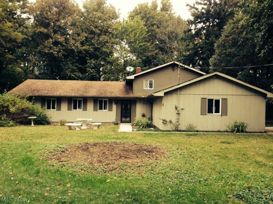 Tucked away on over 5 rolling acres in beautiful Valley City; you'll find this very unique and spacious split level home. Kitchen has been updated with Granite countertops, new cabinets and flooring! Vaulted ceilings and wood/stone accents makes you feel like your living in your own lodge.  The master suite is a private retreat complete with large 2+ person jacuzzi. Enjoy your meals and evening beverages in the exceptional sunroom with beautiful views of the gardens and wooded wonderland. Wood burning fireplace with blower will keep you cozy warm on cold nights. Large 2.5 car, 2 story outbuilding + a 2 car attached garage so bring your toys!  Appraised at $330,000, priced to sell!