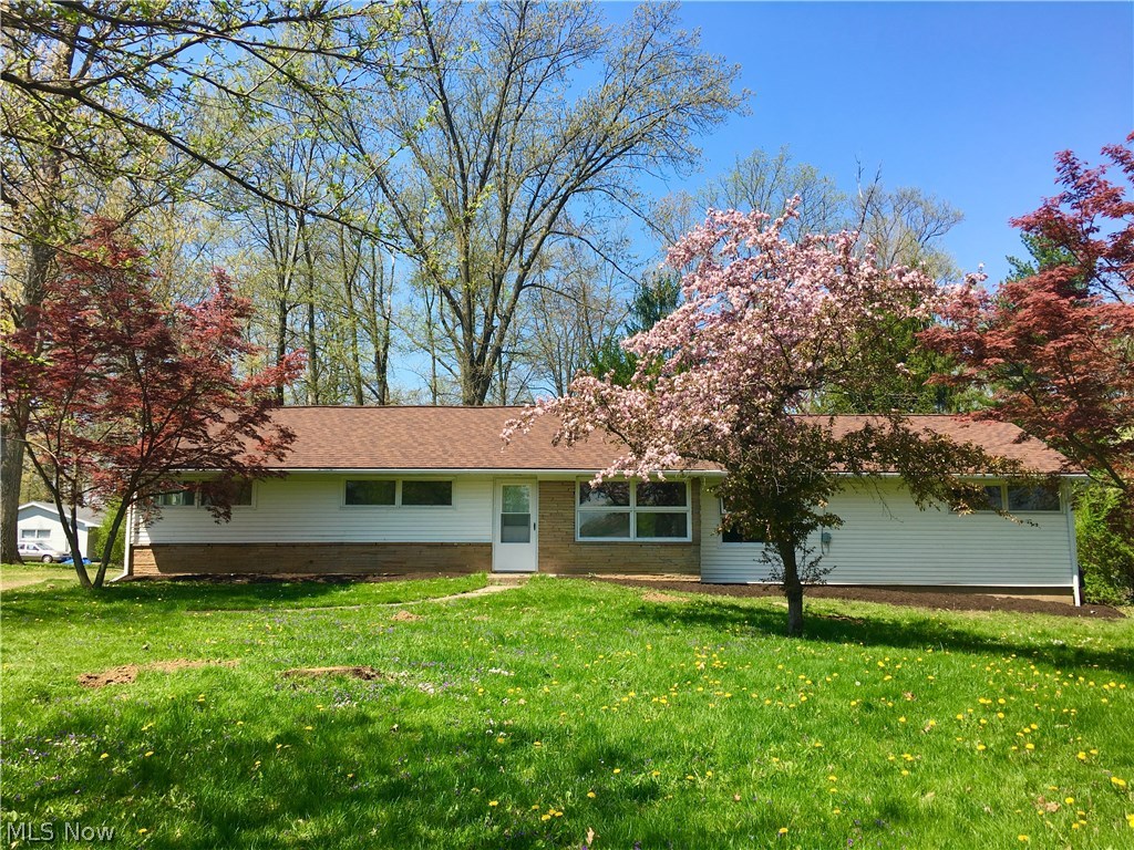 This well maintained, clean 2 bedroom, 1 bath ranch home is set back 80 feet from the road and nestled in a country like setting. Follow the winding gravel pathway around back to the two door attached garage. Enter through the newly painted front door to reveal a very large living room featuring a picturesque wood-burning fireplace. The galley eat-in kitchen comes furnished with a range and dishwasher. The long bonus room off of the kitchen has the option of a wood burner hookup. and can be used as a dining room, mudroom and/or office space. The main bathroom was completely remodeled in 2008. The master bedroom has a large closet and corner windows to flank your bed. The south end of the living room can be made into a third bedroom as it has windows, a closet and a doorway for a door. A glass slider leads to a bright and airy sunroom set amongst lush green foliage and trees. New gravel installed on driveway and new gutters and downspouts put on the back of the home. This home has acces