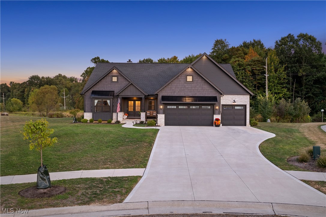 Welcome to your dream home in Danbury Glen Estates! Nestled on a private cul-de-sac and nearly an acre of land, this 2023 custom-built masterpiece by Grisez Homes blends modern design, comfort, and luxury living in the heart of Hartville. Step inside to an open-concept floor plan filled with natural light and thoughtful details. The main level showcases a spacious great room, gourmet kitchen with Cafe appliances, and a flexible office that can double as a sunroom—or be transformed into a 4th bedroom. The primary suite is a true retreat with a spa-like ensuite featuring a walk-in tiled shower, dual sink vanity, an oversized walk-in closet, and convenient access to the laundry room. The finished lower level is a showstopper with an expansive rec/game room, half bath, and plenty of room for a home gym or storage. Outdoors, enjoy your private backyard oasis with a covered porch, cozy patio, and stunning wooded views—perfect for peaceful evenings or entertaining friends. Living in Danbury Glen means more than just a home—it’s a lifestyle. Residents enjoy a clubhouse, heated pool, basketball court, stocked pond, and scenic walking paths. Plus, you’re just minutes from Quail Hollow State Park and part of the highly rated Lake Local Schools district. Don’t miss the rare opportunity to own one of Hartville’s finest homes—schedule your private tour today and experience the elegance, privacy, and community of Danbury Glen living! Special Financing Incentives available on this property from SIRVA Mortgage, ask listing agent for details.