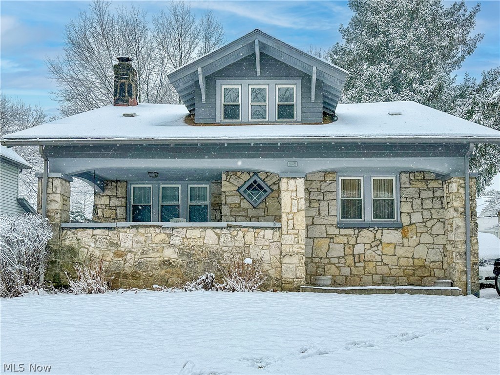 Welcome home to 528 Sunset View Drive! Don't miss this cozy stone-faced century home minutes from Highland square! Enter into a spacious living room boasting a wood burning fireplace and continue into a formal dining room with a window seat and built in cabinets. Your main level also offers a fully applianced kitchen and a half bath. Hardwood floors under all main level carpet! Three bedrooms and full bath are located on the upper level with plenty of closet space.
The walkout basement offers loads of shelves and storage space. Enjoy your summer evenings swinging on your front porch or entertaining guests in your private backyard. Don't miss your opportunity to own this home. Schedule your private viewing today!