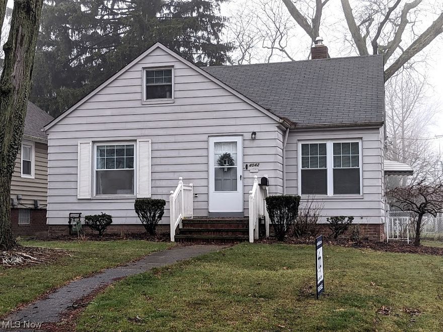 Gleaming hardwood floors adorn the first floor of this charming 1950s modern bungalow! Welcoming vestibule with convenient coat closet leads you to a nice sized living room with coved ceilings. Fully outfitted eat-in kitchen includes tasteful luxury vinyl flooring, pretty subway tile backsplash and sliding doors to a cozy deck and access to the large fenced yard. Two ample sized bedrooms (one currently used as a dining room) and an updated full bath complete the main level. Classic spindled staircase brings you to the warm and comfortable dormer bedroom used as the owner's suite. Full basement features glass block windows and is partitioned into a spacious rec-room, laundry room (including washer & dryer) and small storage room offering the potential for a workshop or other uses. Updated electrical panel & vinyl windows throughout. Terrific location with easy access to conveniences, shopping, rec center, freeways and the airport. Immediate occupancy available.