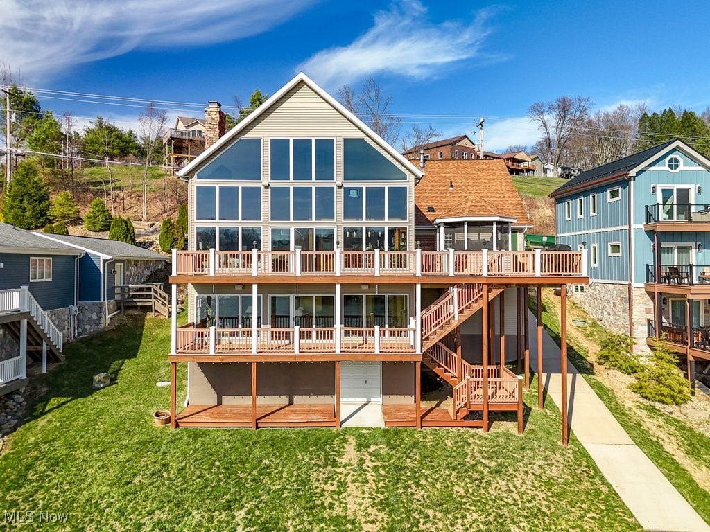 This stunning 2008 custom-built lakefront home is a true retreat, offering breathtaking lake views and a seamless blend of comfort and luxury. Designed for both relaxation and entertaining, this home boasts a spacious great room with soaring cathedral ceilings, a dramatic wall of windows, and a cozy wood-burning fireplace, all showcasing the panoramic lake views. The gourmet kitchen features granite countertops, a high-end Viking refrigerator, a brand-new stove and hood, and a stylish breakfast bar—perfect for hosting and everyday living. Step outside to the expansive composite deck, where a charming screened-in gazebo offers the perfect spot for alfresco dining or unwinding with a view. The main-level owner’s suite has been beautifully refreshed with new paint, dual granite vanities, a luxurious tile shower, and a spacious walk-in closet. The lower-level walkout is designed for comfort and functionality, featuring a dedicated office, an additional bedroom, a full bath, and a warm and inviting family room with its own fireplace. A wall of windows fills the space with natural light, while sliding glass doors lead to a private lower deck, providing even more opportunities to take in the tranquil lake setting. Upstairs, the loft area is an inviting retreat, offering two additional bedrooms, a full bath, and an open loft space with breathtaking views—the perfect spot for a reading nook or bonus entertainment area. Equipped with two furnaces (one new in 2024), two A/C units (2025), a tankless water heater (2021), and a new water softener (2024), this home is move-in ready. The lakefront area features electric, a shed, a dock, and a built-in patio for the ultimate waterfront experience. Located in Lake Mohawk, a private, gated community with a 500-acre lake (unlimited horsepower boating, swimming, and fishing), plus tennis courts, a baseball field, and a clubhouse. Schedule your private showing today!