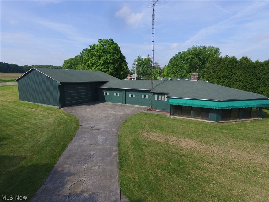Wait until you see this place! Garage lover's paradise. Featuring an attached 4.5 car finished garage connected to a 40' x 50' heated, clear span building with 12' high clearance situated on a .83 acre lot with room to expanded the garages and the home. Very unique, one owner, one of a kind home with a hexagon design. Enter through the wrap around enclosed porch which leads into the open design of the great room with a fireplace and the kitchen area. The master bedroom has a walk-in closet and a half bath. There is a second bedroom and a full bath. The laundry/utility room combo has the mechanics for the home. The heat pump with air conditioning has been recently updated. Both the home and garages are very well insulated. The property is in Green Township, business zoning (being used as a residence currently) Canfield Schools. This is a rare opportunity with an enormous amount of potential and numerous uses.  Don't delay. Call Today.