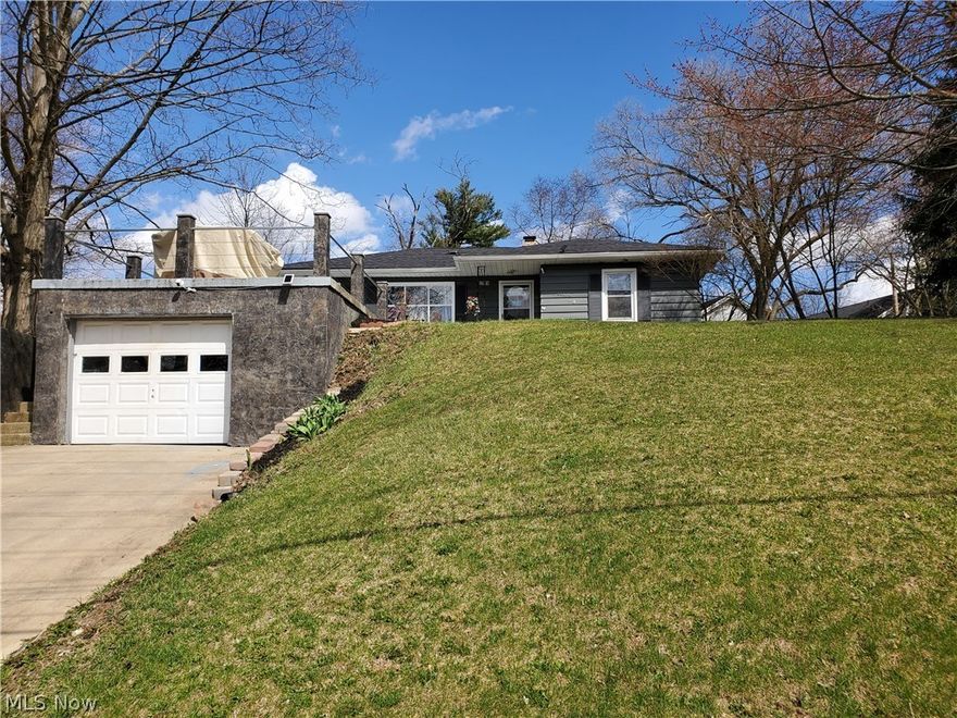 Amazing property is so much larger than it looks!  This raised ranch offers a large living/dining area with windows allowing for an abundance of natural light.  A nice kitchen with newer marble countertop, refrigerator and dishwasher (all appliances convey).  Three good sized bedrooms with a slider off one of them to a nice covered deck and private backyard.  The lower level could be an additional living suite which features a full kitchen (all appliances convey as well), large recreation room (part of which is currently being used as a bedroom) and another finished room for an office.  The garage is noted as a 1 car; however, is actually a 2 car tandem garage.  I love the concrete patio above the garage for grilling and entertaining. Updates include:  Roof - 2017; laminate flooring throughout, porch roof, 1 new kitchen window, newer sliding glass patio door, sump pump, ceiling fans and 2 toilets.  Home warranty is being offered by the seller.  Two additional parcels convey and 2 sheds