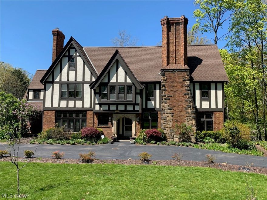 *** A MUST SEE ~ MOVE IN CONDITION ***  Absolutely STUNNING Tudor on a beautiful private, landscaped lot.  This exceptionally maintained and beautifully decorated 5/7 bedroom; 3 story;  4.5 bath home has had many major improvements and upgrades in the last 6 years.  Get the best of both worlds -  exquisite character and detailing coupled with today's amenities.  Incredible Chef’s kitchen (Major 2014 Renovation).  Custom cabinets with granite countertops and recessed refrigerator.  Deluxe Center  Island.   Appliances stay. French doors lead to the formal dining room.  Spacious living room with wood/gas burning fire place and mounted flat screen TV.  Exquisite crown molding in many rooms, original lead windows, chestnut hardwood flooring and fresh neutral paint color throughout the interior.  Paneled Conservatory/Den with wood/gas burning fireplace and built in book shelves.  Fabulous master suite with walk in closet and cozy gas fire place and recessed TV.   Second floor laundry room wi