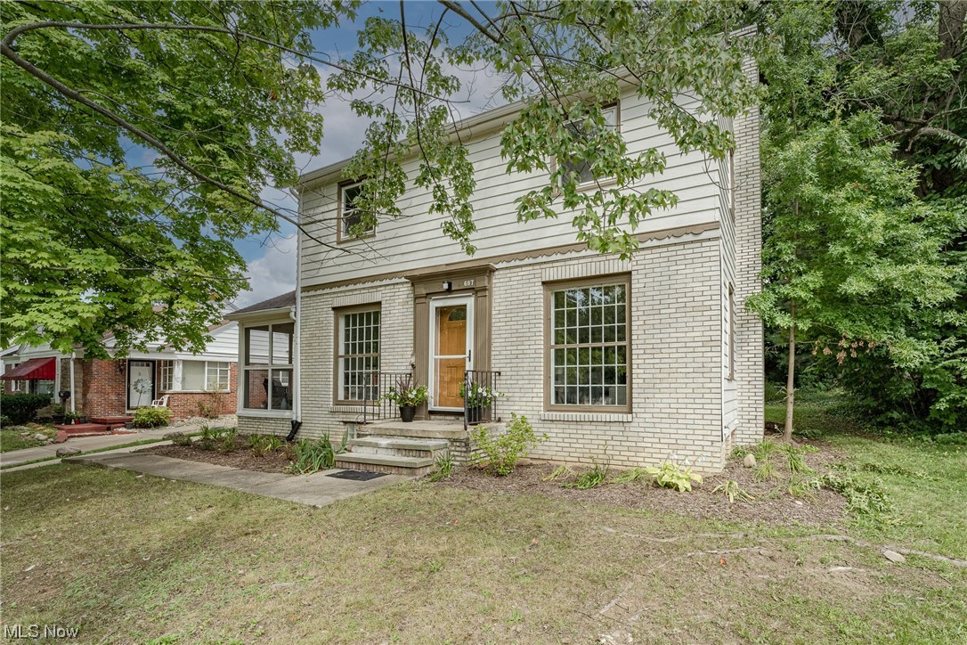 Move right into this charming colonial on a quiet street in West Akron! This delightful home has been extensively updated with highlights including gleaming hardwood floors, new central AC, renovated bathrooms, and fresh paint throughout the interior! The front door opens into a foyer area with the dining room on your left and the living room on you right. The living room features an elegant fireplace, abundant natural light, and refinished hardwood floors that flow throughout the home. The equally bright and airy dining room includes updated wall sconces as well as a french door that opens to a screened-in porch. Behind the dining room, the kitchen features ceramic tile flooring, a breakfast nook, ceramic tile flooring, and plenty of cabinet space. A convenient half bath by the back door completes the first floor. Upstairs, there is a delightful landing that connects to three generously sized bedrooms, all with plenty of sunlight and hardwood floors. The tastefully updated full bathro