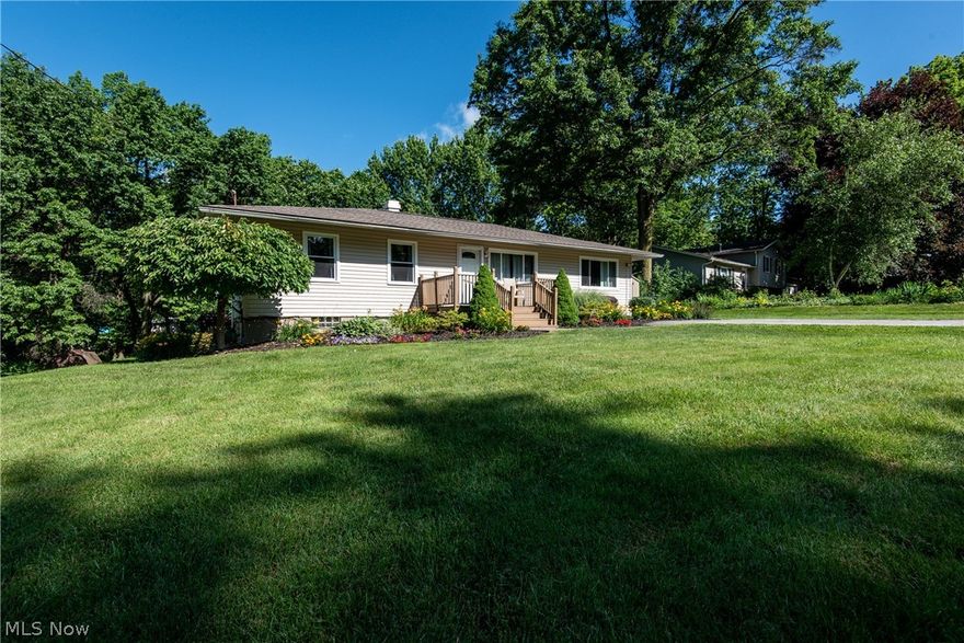 CONVENIENTLY LOCATED 3 BEDROOM 1 BATH RANCH IN GREEN ON ALMOST HALF AN ACRE OF LAND! Walk through the front entrance into the spacious living room with neutral decor, carpet, and a newer bay window that brings in lots of natural light. In the nicely updated kitchen, you will find newer linoleum flooring, Formica counters,  plenty of oak cabinets, a breakfast bar, and appliances that stay. The dining room is open to the kitchen and features laminate flooring, two closets for additional storage, and a large window overlooking the deck. Located off of the dining room is a nice family room with the same laminate flooring and another large bay window that fills the room with natural light. This home also features 3 bedrooms with carpet and ceiling fans in each bedroom plus a full bathroom that was remodeled 4 years ago with newer tile flooring, single vanity and a tub/shower combo. The 11-course basement features a semi-finished area, access to the backyard, and you could add another bathro