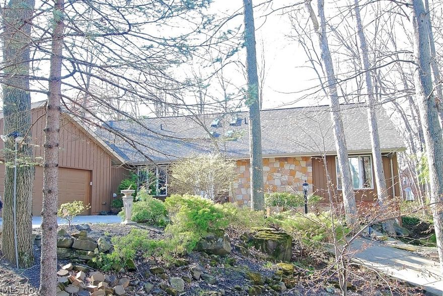 Located in Bradford Village near the Brecksville Reservation/Cleveland Metroparks. Substantial improvements between 2011 and 2015: replacement of furnaces with high efficiency and a/c units, full exterior and interior painting, new roof in late 2014, replaced hardwood and hardwood laminate floors on first floor, removal of fourteen Ash trees, large stamped concrete patio with exterior lighting upgrades, backyard excavation and landscaping, and installation of second driveway with new concrete walkways.

All rooms are generous in size & offer spectacular views. The kitchen has been updated and has ss appliances, hardwood flooring with cabinetry in a medium maple finish, and first floor utility/mud room. There is a gas fireplace, with brick surround & hearth, plus a window wall overlooking the back yard. A private deck is accessed by living room and master bedroom. Upstairs are three spacious bedrooms, with built-ins & vaulted ceilings. The third bedroom has a 15 x 10 adjoining room, p