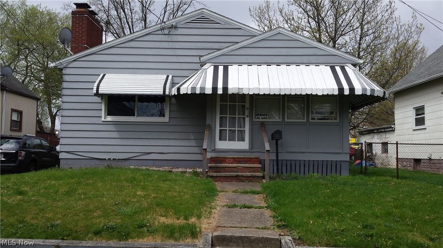 Stop paying rent, this is cheaper!!!   Move- in ready!  This home features a sunny, enclosed front porch and a private, back patio for relaxation.  The large living room, with a wood-burning fireplace, has plenty of room for a dining room area.  The kitchen is open to the living room and has a convenient breakfast bar.  All appliances stay including the washer and dryer.  Updated bath.  The office in the lower level could easily be used as a third bedroom.  The huge recreation room has a built-in bar that is perfect for entertaining.  The back yard is completely fenced.  The two-car garage is behind the home and accessed from Ray St.  This sale includes two parcels.  Motivated seller.  All offers will be considered.