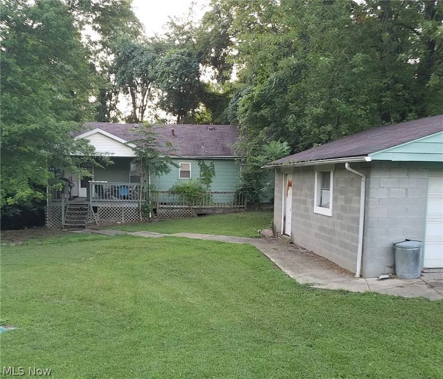 House has been gutted inside. Exterior is in solid condition. Needs new kitchen, heating, AC system, drywall and floor coverings, on approx. 1/2 acre private lot with a single car garage and a double car garage. Great potential!