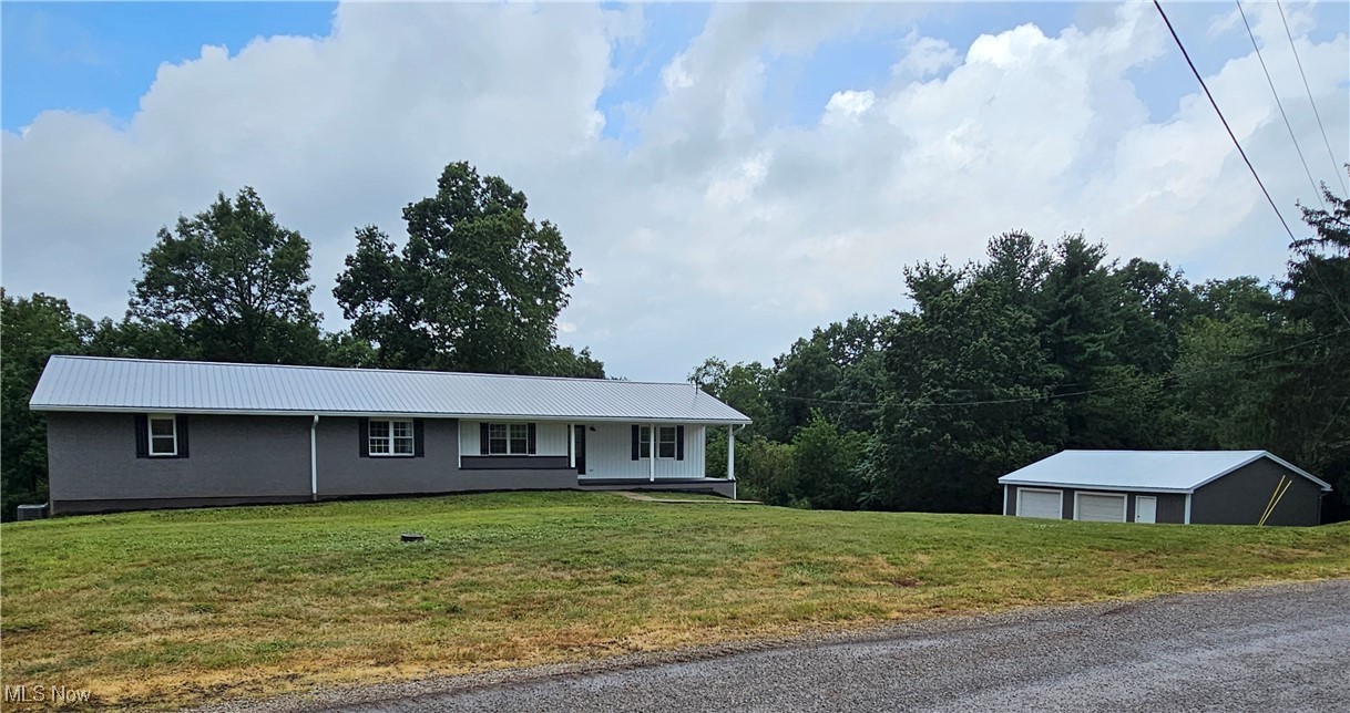 This stunning 4-bedroom, 3-bath home in a peaceful country setting has been beautifully transformed—taken down to the studs and completely refinished on the first floor and partially finished in the basement for even more living space.
The heart of the home is the open living, dining, and kitchen area, featuring a built-in coffee/appliance bar, custom shelving, quartz countertops, black quartz sink, backsplash, new stainless steel appliances, and recessed lighting. The spacious master suite offers a private retreat with a large walk-in shower, double vanity, and stylish accent lighting and mirrors. Three additional bedrooms are perfect for family, guests, or a home office. The main bath is home to the laundry hook-ups making it convenient on the main level of the home.
Downstairs adds about 700 sq. ft. of living space with two large rooms, a full bath, one-car garage, “toy” garage, and abundant storage. A new sliding glass door opens from the dining area to a large back deck overlooking the back part of the 8+ acres—ideal for a mini-farm, complete with a barn featuring a tall garage door and high beams. The oversized 2-car detached garage offers even more space for storage or a private getaway space. Think man cave or she shed!! The exterior of the home was painted as part of the remodel so there's no work required on the exterior for the new owner! The new furnace and central air unit and the newer roof are added bonuses you should not have to worry about for a long time!
Some finishing touches remain, but this home is move in ready and can be shown today. Call your agent for a private tour!