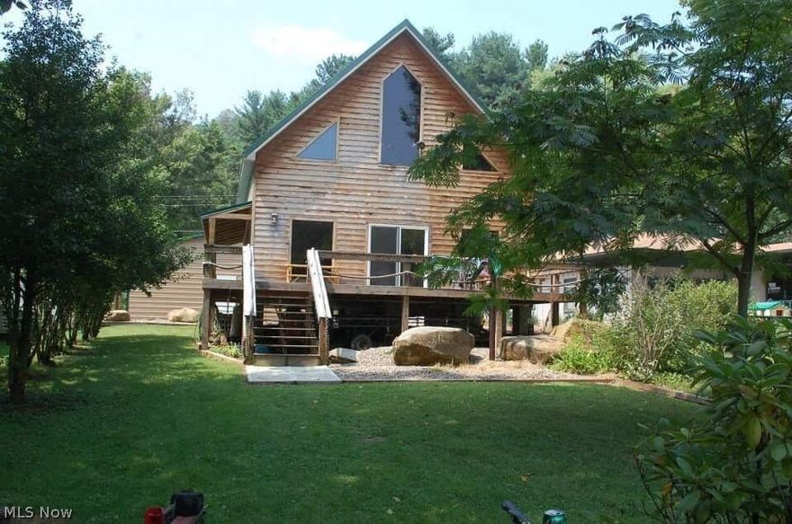 Have you been searching for the perfect riverfront property?  Look no longer!  This beautiful home offers hardwood floors throughout, hickory cabinets, open floor plan with high cathedral ceiling leading up to an open loft.  Outside you will find a large wrap around deck, a boathouse and two car garage with electric and wood stove to assure you will stay warm.  This is a very peaceful property!  Schedule your showing today!