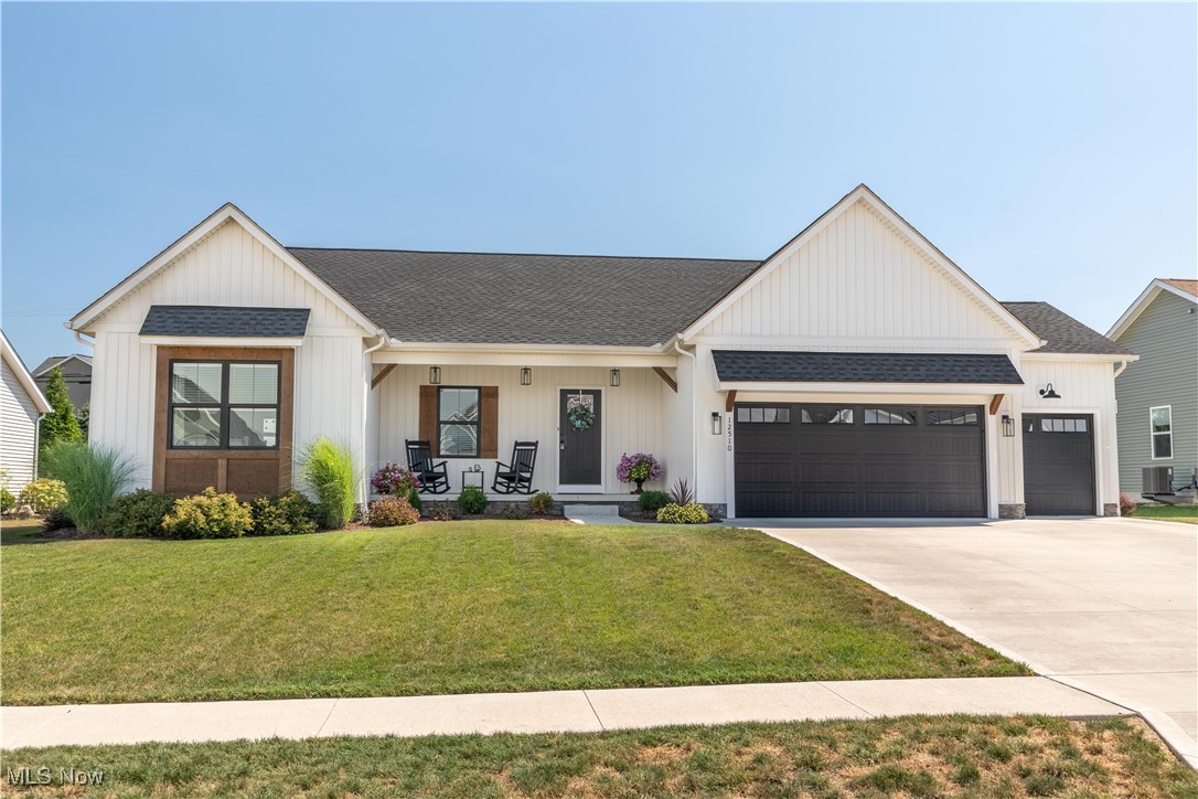 Welcome to this stunning ranch-style home built by Grisez Homes in Lake LSD! Offering 3 bedrooms, 2.5 baths, and 2,774 sq. ft. of quality living space, this move-in-ready home blends timeless design with modern finishes. Step inside to an inviting foyer that opens to the spacious great room, where vaulted ceilings with a wood beam, a stone-surround fireplace, and abundant natural light create a warm, welcoming atmosphere. The open-concept layout flows seamlessly into the kitchen, perfect for both everyday living and entertaining. The kitchen is a showstopper, featuring an oversized island with a breakfast bar, crisp white cabinetry with bold black hardware, a tile backsplash, a walk-in pantry, and a chandelier. A dining area with sliding glass doors extends the living space outdoors to the back patio, ideal for summer evenings. Two generously sized bedrooms with large closets and a full bathroom are located just off the kitchen. The private master suite is tucked away off the great room and includes backyard views, a spa-like bath with a double vanity, tilting mirrors, a tiled walk-in shower, and a spacious 7x12 walk-in closet. For added convenience, the first-floor laundry connects directly to the master closet and sits next to the mudroom with a built-in drop zone. The finished lower level adds even more living space, featuring a large recreation room, a half bath, and ample storage. An attached 3-car garage with extra storage completes the package. Recent updates include the sandstone retaining wall in the back of the property and all of the meticulous landscaping. Don’t miss your chance to call this beautiful home yours. Schedule your private showing today!