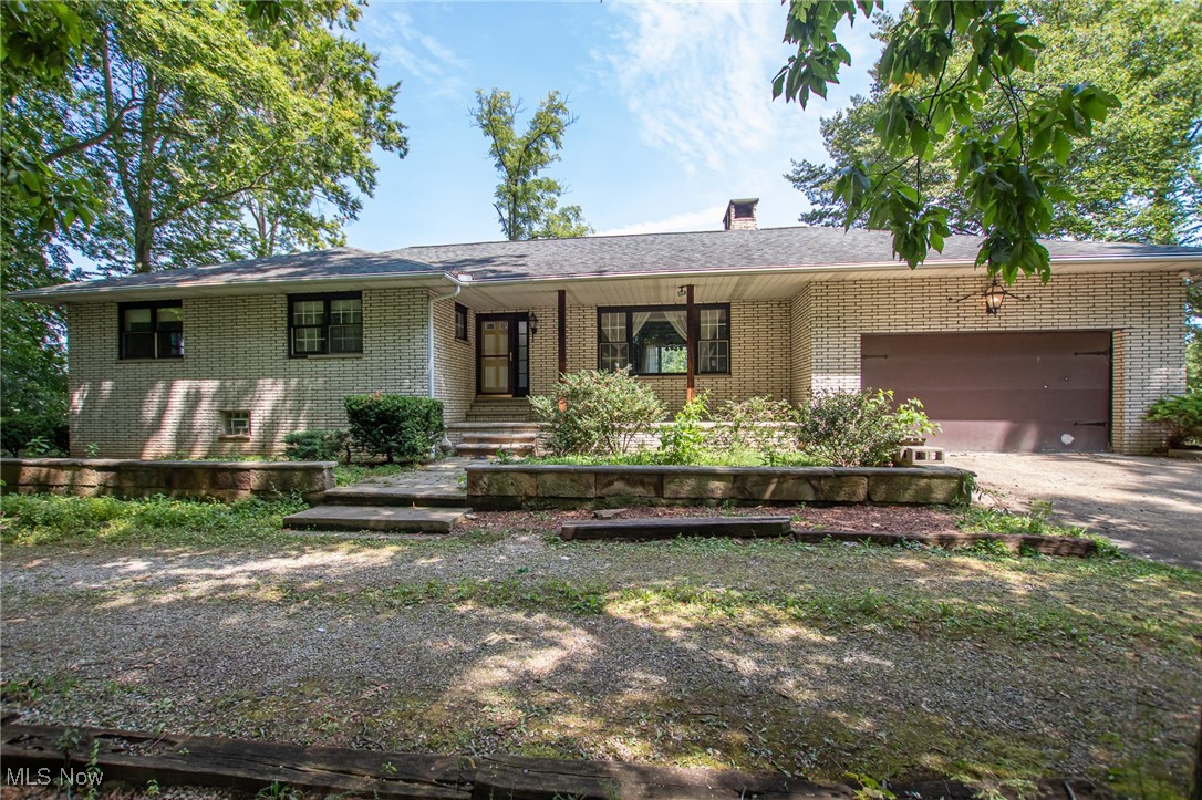 Sprawling ranch with lots of potential! Located on 4.4 acres in Revere Schools. Features include: hardwood floors, a woodburning fireplace insert, attached garage, and a full basement. Bring your design ideas to life! Would also make a great rental. Conveniently located just minutes from I-77 and the Turnpike.