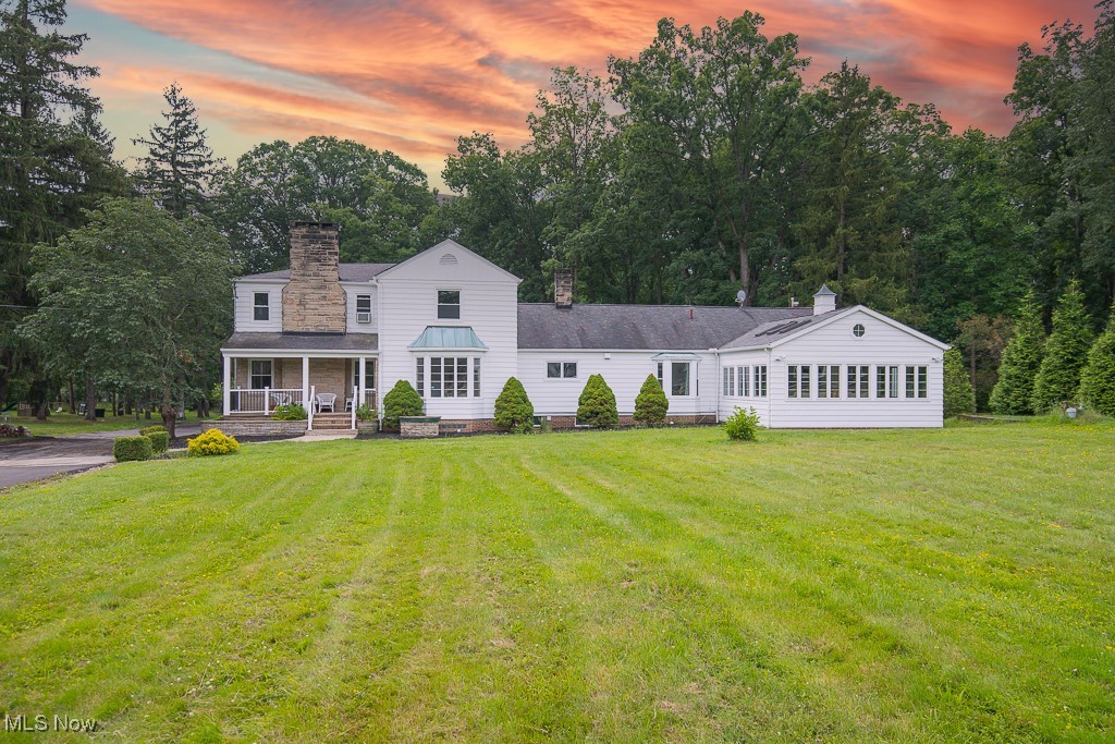 Welcome to your dream home, a breathtaking retreat nestled in a private country setting, offering an incredible 7.5 acres of wooded paradise. This magnificent 4 bedroom property features a spacious 5,210 sq ft main residence, complemented by a charming second dwelling perfect for a home office, party space, or guest accommodations. With a remarkable depth of 2,340 feet, this estate embraces the serene beauty of Chippewa Creek, providing a tranquil backdrop for family life. The residence boasts brand new windows that flood the space with natural light, along with stunning new kitchen cabinets and quartz countertops that elevate the culinary experience. The meticulous updates include fresh interior and exterior paint, new flooring throughout the first floor, and a newly coated asphalt driveway. The luxurious master suite features a cozy wood-burning fireplace, a walk-in cedar closet, an additional closet, and a private balcony that invites you to unwind. The second floor hosts three large bedrooms, while the first floor offers a guest room with an adjoining full bath, ideal for an in-law suite. The great room, an impressive 27’ x 22’, showcases a vaulted ceiling, beautiful wood flooring, a full bar, and a gas fireplace, making it the perfect gathering spot. The sunroom, offers 25 windows, 6 skylights, & is a plant lover's paradise, while the living room and dining room, both adorned with wood-burning fireplaces, offer cozy settings for family gatherings. The dining room features French doors that open to a private veranda overlooking the scenic backyard. The secondary residence includes its own stone driveway, kitchen, and half bath, along with a pavilion that can accommodate over 75 guests for events, rain or shine. The expansive acreage is perfect for outdoor adventures, with ample space for horses, paddocks, a barn, hiking, and even a campsite. Located within prestigious blue ribbon school district. 1yr home warranty offered,.call today for your private tour