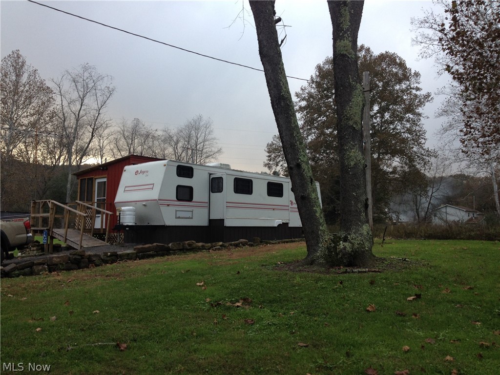 Are you looking for casual living, weekend get away or a hunting camp that you always wanted? Then this is the property for you. Featuring a 8'x35' camper sleeps 6 with a 3'x15' slide out. Furnished with stove, refridgerator, microwave and bedroom furniture. Enjoy the 12'x24' screened in porch attached to the camper for that morning coffee or evening relaxation. A 29'x29' metal building is just waiting for your workshop or 4 wheeler garage. The storage shed is connected to your 3 chicken coops. This property is only miles from Highlandtown Lake, state game lands and just down the road take your 4 wheeler for miles of riding fun. Property has electric, propane, well and septic. Call now for that comfort living with that outdoor touch.
