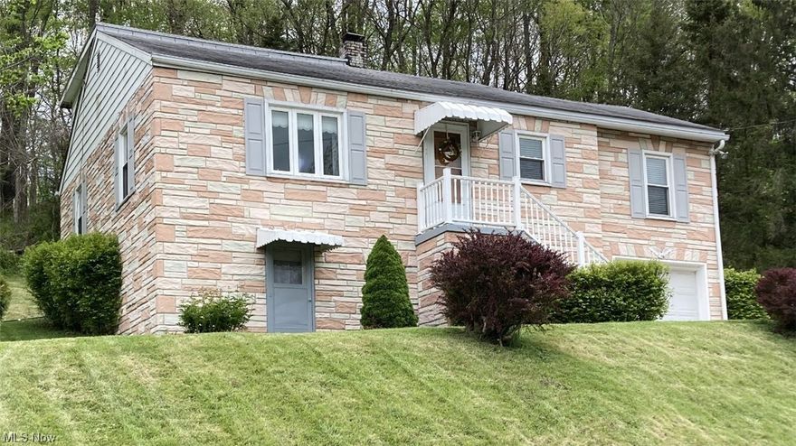 Crisp, clean & move-in ready!!  New carpeting throughout.  Hardwood floors.  Updated bathroom.  Double closets in the bedrooms.  Great floor plan w/2 bedrooms on main level.  Private back covered porch.  Remodeled lower level game/family room w/walkout.  Abundant basement space for laundry & storage.  Private rear yard.  Integral front entry garage & paved driveway.