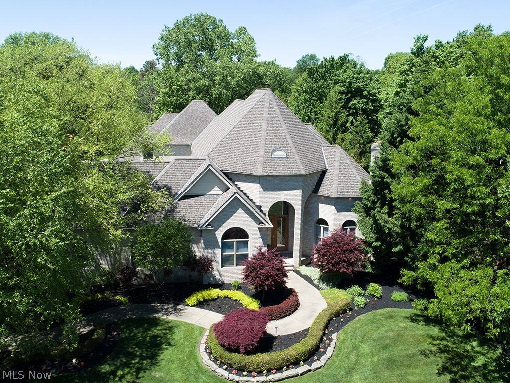 Stunning all brick home with transitional contemporary styling and extraordinary attention to custom details, located adjacent to acres of nature preserve with trails. You will love the open floor plan which allows for either formal or casual entertaining, plus comfortable every day living. The first floor offers grand expansive foyer/formal dining space, along with winding staircase to 2nd level loft and bedrooms. In addition, you will enjoy the formal living room with gas fireplace, vaulted study, chef’s delight Leicht kitchen with double island seating plus spacious dinette that is open to the great room with 2nd fireplace and built-in entertainment center with storage. The glamour Owner's suite is conveniently located on the 1st floor and offers access to the in-ground pool and private courtyard sitting area. The second level features 3 additional bedrooms, all with either private or jack-n-jill baths and ample closet areas. An additional 3,000SF of finished living space in the lower level includes bar/entertainment area, home theatre room with all equipment and kitchen area, 5th bedroom, full bath with sauna room, pool room and exercise room. All 4 garage bays are heated, plus additional loft storage. The in-ground pool with water feature is nestled in a private courtyard, accessed via back yard, dinette or owner's suite bath.