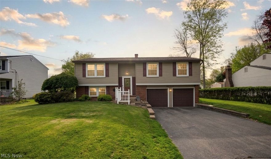 This three-bedroom split-level house in Austintown boasts a spacious living room ideal for entertaining, a versatile basement with extra living space and storage, and a large backyard patio accessible from the dining room, perfect for outdoor gatherings. The property also features a two-car garage for convenient parking and additional storage, making it a practical and inviting home.