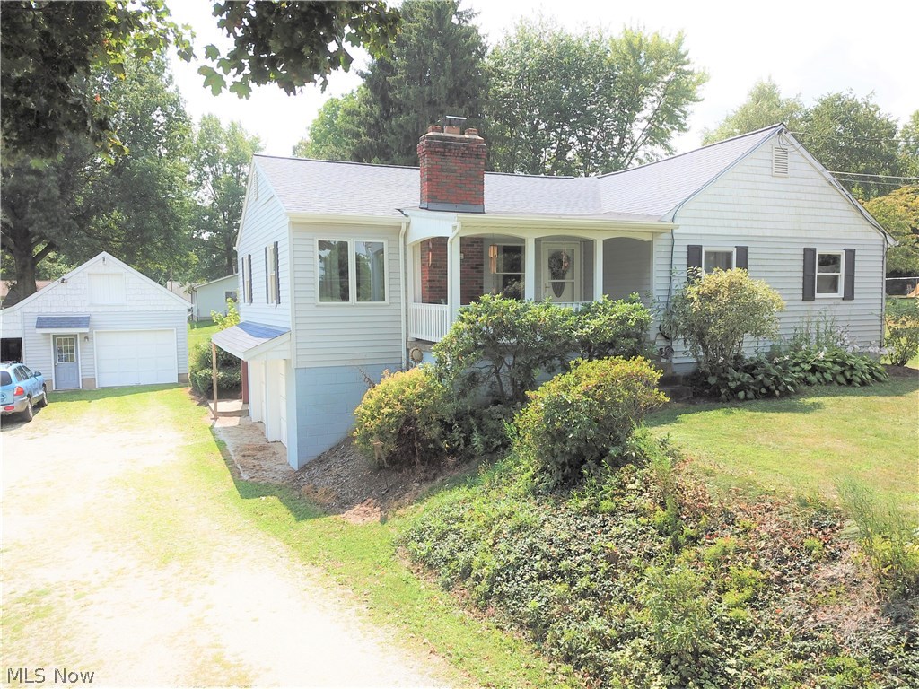 This delightful, 4-bedroom, two-and-a-half bath home is sure to impress with its many features! You'll immediately fall in love with the covered front porch that offers peaceful outdoor seating away from the road. Step inside to see the large, carpeted living room. The windows and brick fireplace make this room exceptionally cozy and inviting. The eat-in kitchen has beautiful cherry-stained cabinets and french doors that lead to the large wooden deck in the back, perfect for entertaining outdoors! The sizable master suite has two closets, built-in drawers, and a bathroom with a corner Jacuzzi tub. This home also features a large bonus room with wood floors that can be used as a family room, dining room, play room -- the options are endless! This house has three garages (two are attached) which offers a ton of extra storage space. Don't miss out; call today to schedule a showing!