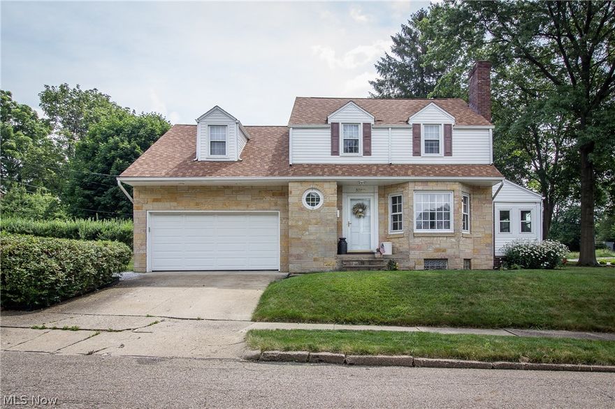WHAT A CHARMER! This Market Heights home has been updated with modern decor that highlights its original charm. Enter into the inviting living room with a wood burning fireplace with stone surround and huge bay windows. The kitchen features tiled counters and backsplash, newer stainless steel appliances and gorgeous hardwood flooring that leads to the dining room. An enclosed sunroom with Nature Stone flooring is a perfect place to relax or you could continue to use as a play room! Upstairs the hardwood floors continue throughout the two of the three bedrooms that share the bright, updated full bath. The lower level includes an approx. 300 additional sq. ft. of living space. A rec room with a second fireplace with tile surround and nature stone flooring provides a cozy spot to curl up with a book or watch a movie plus there is a convenient half bath! There is also an attached 2 car garage and a nice side yard surrounded by manicured hedges. Updates include newer appliances, Nature Ston