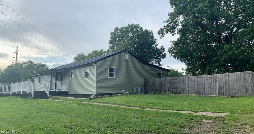 Welcome HOME.  This open concept ranch home sits on 3.93 acres.  This home features an inviting kitchen with all newer appliances, kitchen island with bar stools.  The dining room opens to a oversized living room with a pallet stove and a large front deck.   2 bedrooms on the main floor with the laundry room in the lower level.  Washer and Dryer stay with the home.  There is an enclosed back porch leading to a private deck with beautiful views of the valley.  The garage is 32 x 32 which is equipped with electric, newer wiring, fully insulated and drywalled. There is also water and a cement floor with drain.  This home has had many updates including full remodel inside in 2020 along with a new roof in 2021, new siding in 2021, newer electrical in 2020, newer plumbing in 2020 and a new hot water tank in 2020.  This home has a beautiful country setting located just outside of town with city utilities, acreage and a huge garage.