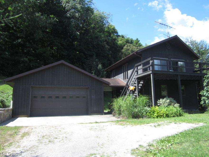 Very unique, quality home on a beautiful country setting just minutes from Warsaw. This 32 acres  is perfect for country living in a private setting.  About 8 acres of open, mowed lawns with the rest in solid, mature timber.  This is an excellent "get-away retreat", recreational property or permanent residence.  This home is very well maintained and ready to move into. Includes large 2nd story deck, patio, spiral stairway, full basement and large 2 car garage. Owned mineral rights transfer.