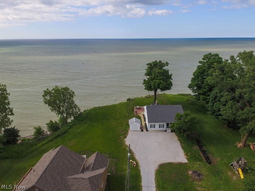 Magnificent sunsets and lake views from this updated home on .72 acre lot with break wall. Move right in to this one of a kind coastal gem.New 2018 gourmet eat in kitchen with quartz tops, laminate flooring, natural light, breakfast bar and stainless Whirlpool Gold appliances, corner full wall windows enhance the living room with breathtaking Lake Erie views plus laminate flooring & stone gas fireplace, double barn doors lead to a dramatic step down master suite (new carpet to be installed by 7/2018), first floor office with hardwood flooring, bedroom #2 with hardwood flooring plus updated full bath with full size stack washer/dryer, Glass and screened sunroom to enjoy the lake breezes, Upper level offers bedroom #3, a carpeted loft, an office / playroom plus a second, updated full bath with tub & shower stall, Waterproofed basement with semi-completed rec room with dry bar & extra fridge for entertaining, storage room and furnace room, Whole house Generac generator, New interior and e