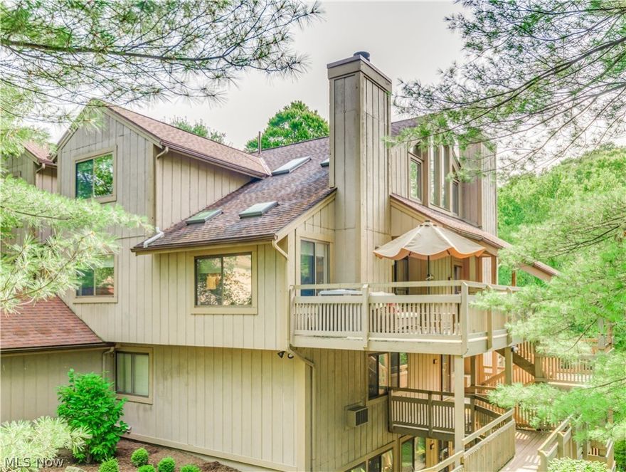 Just move in and enjoy condo living in this exceptional end unit that backs up to a beautiful park like setting in the desirable Pine Mill Ridge area.  Gorgeous view of the woods and stream.  Spacious great room with a stone fireplace and loads of windows.  Updated kitchen fully appliances. First floor bedrooms and the master bedroom on the 2nd floor is open and air with vaulted ceiling with its own bathroom.  Loft area with newer skylights.  You will love the deck, the views and the tranquility of the outdoors. Enjoy the association pool!  Additional updates:  A/C compressor replaced 2019, master bath new tile floor, 1/2 bath new tile floor, kitchen back splash, newer fans installed in the spare bedroom loft and living room.