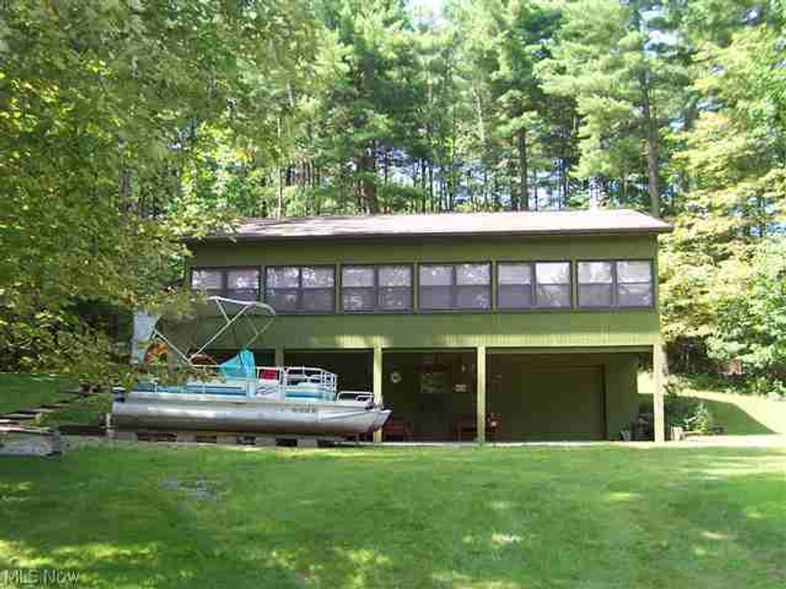 Adorable "like-new" lake home perched above Piedmont Lake! Third bedroom possible in basement.  Beautiful 11' X 38' enclosed front porch (family room) with windows all around!  Pontoon boat and golf cart included in sale.  Leased land from Muskingum Watershed, $1,400 per year.