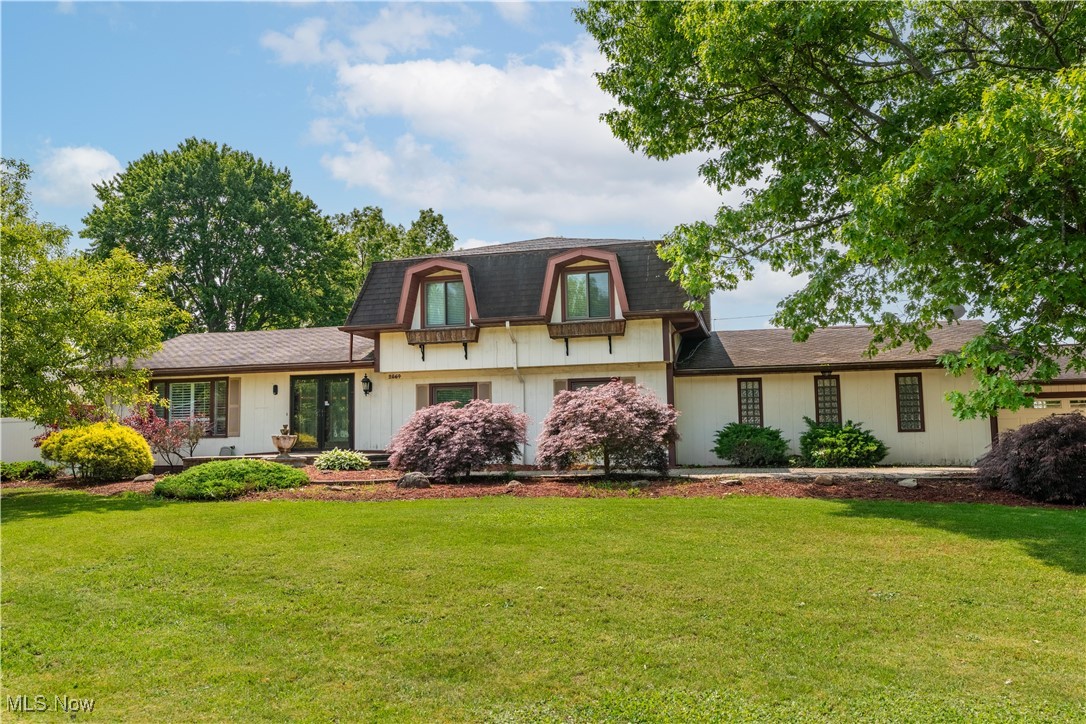 This spacious split-level home with a finished basement offers over 3,000 sq. ft. of bright, inviting living space designed for hosting unforgettable gatherings. From the moment you enter the welcoming foyer, you’re greeted by glass double doors leading into the great room with vaulted ceilings, a grand staircase, and seamless flow into the formal dining room, complete with a chandelier. The eat-in kitchen features abundant cabinetry, a tile backsplash, a large pantry, and a generous breakfast bar perfect for casual meals or pre-party mingling. Views of the backyard oasis add even more charm. Downstairs, the cozy family room offers the perfect spot to relax, with a brick wood-burning fireplace and double doors that lead directly to the ultimate backyard entertainment zone. Step outside to find a private, fenced-in retreat with a deck, a patio, an inground pool, a fun tiki bar setup, and a mini pool house/shed for convenient storage. But the party doesn’t stop there! One bay of the detached 4-car garage has been transformed into a stylish recreation room complete with tile floors, a gas fireplace, a full bar with a sink, and a mini fridge, ideal for year-round hosting. The lower level also features a guest bedroom, a half bath, a laundry room, and access to the attached 2-car garage. Upstairs, you’ll find three generous bedrooms and two full baths, including a spacious primary suite with two closets, abundant natural light, and a beautiful primary bathroom with a tile walk-in shower and built-in storage. And finally, the finished basement is a host’s dream! With a second bar area featuring ample seating, wine storage, built-in TVs, a mini fridge, a sink, and a full-size refrigerator, there's more than enough room to gather, watch the big game, or celebrate every special occasion in style. This home has it all—space, style, and every feature an entertainer could want. Don’t miss your chance to tour this unique property. Schedule your private showing today!
